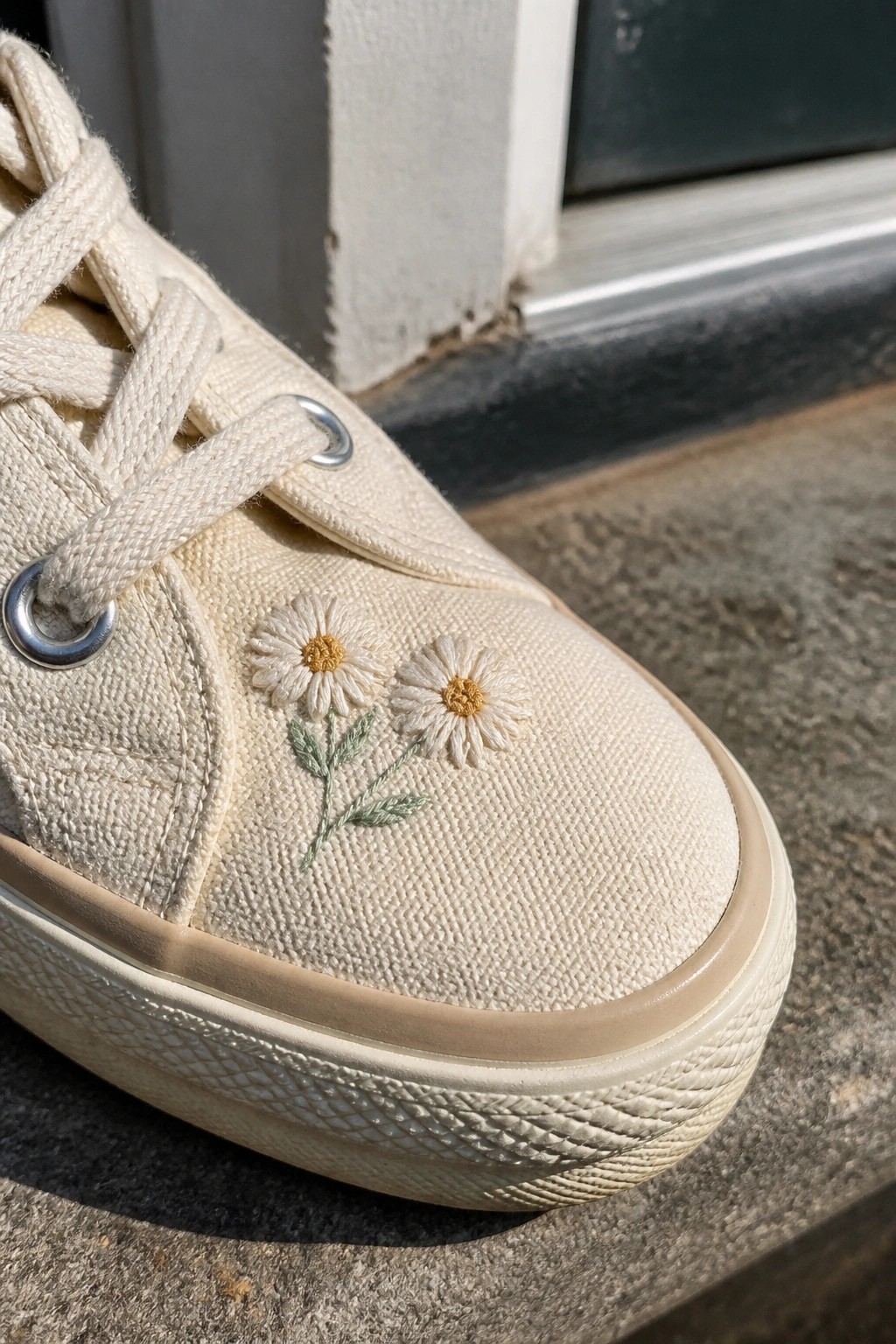 Cream canvas sneaker with white daisy embroidery on beige sole