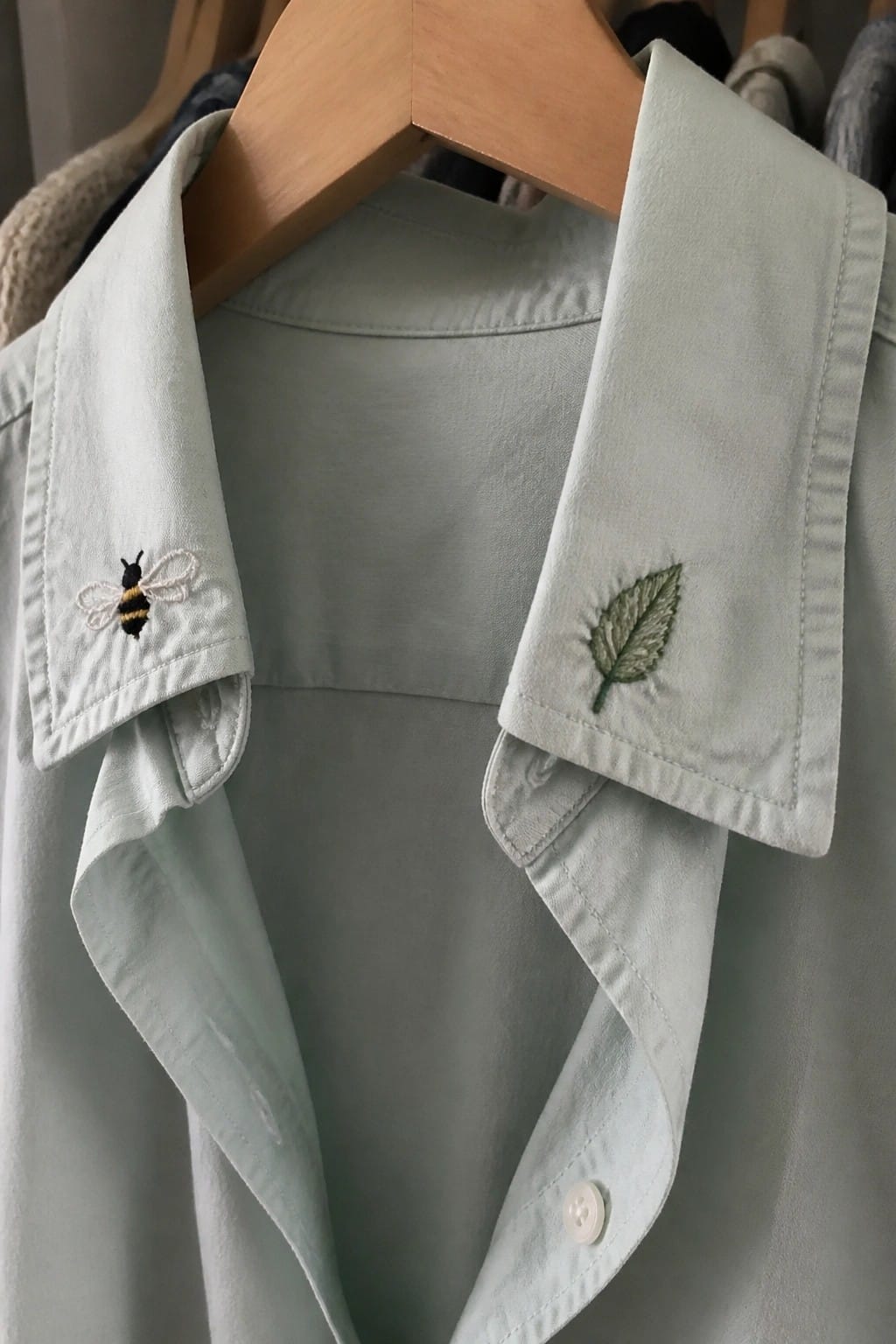 Mint green button-up shirt with embroidered bee and leaf on collar flaps