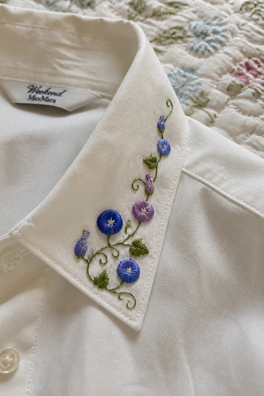 White MaxMara shirt collar with blue and purple floral embroidery.