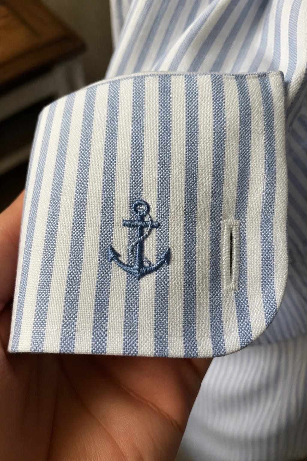 Navy blazer breast pocket holding white pocket square with embroidered tulips.