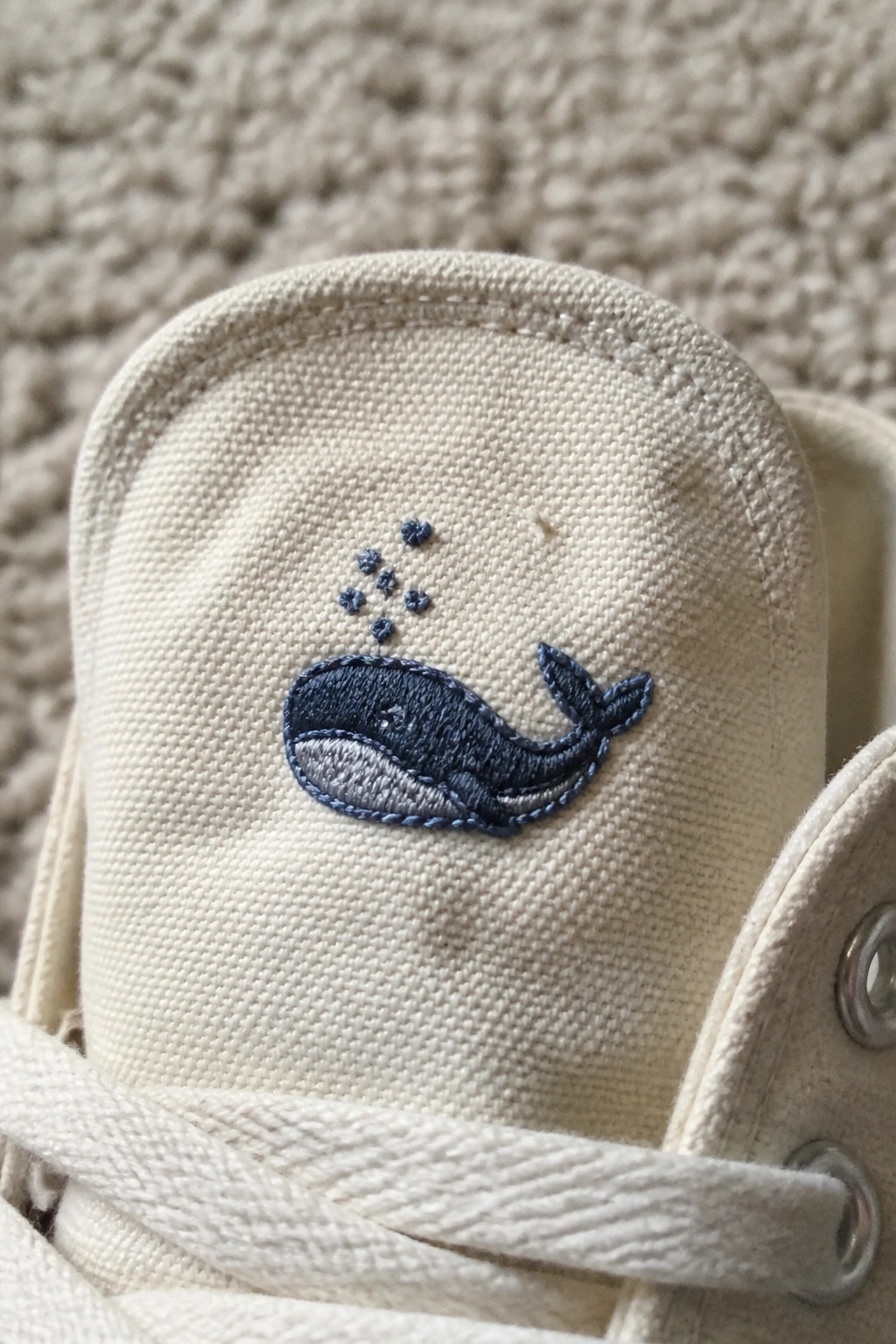 Cream canvas sneaker with embroidered blue whale and bubbles on toe