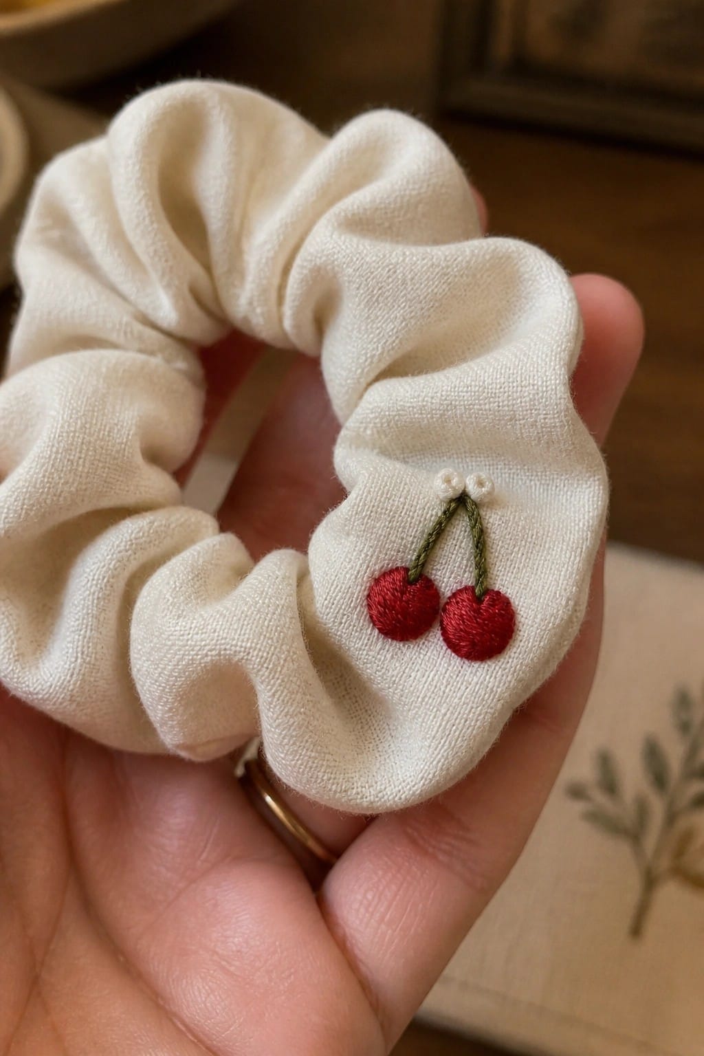 A round hedgehog embroidery holding a heart centered on a white pillow.