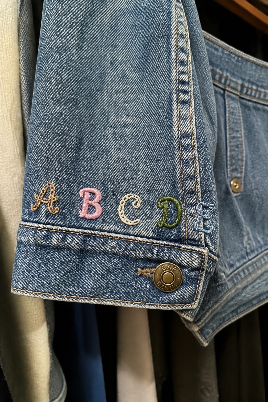 Blue denim cuff embroidered with colorful A B C D E letters and GAP button