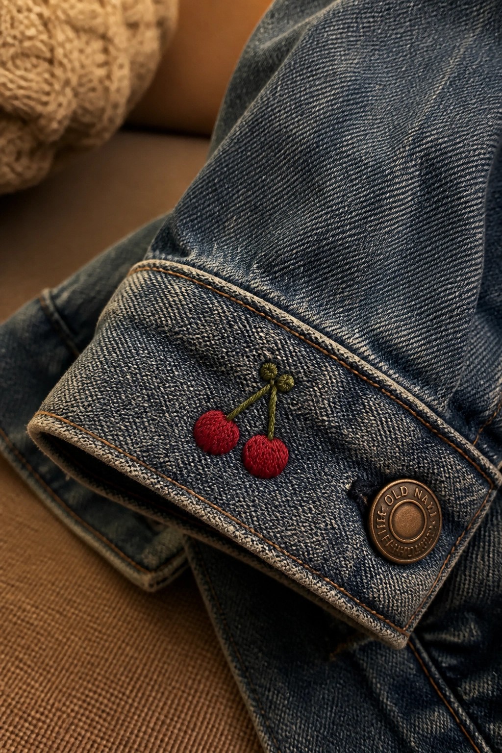 Blue denim cuff with red cherry embroidery and Old Navy button