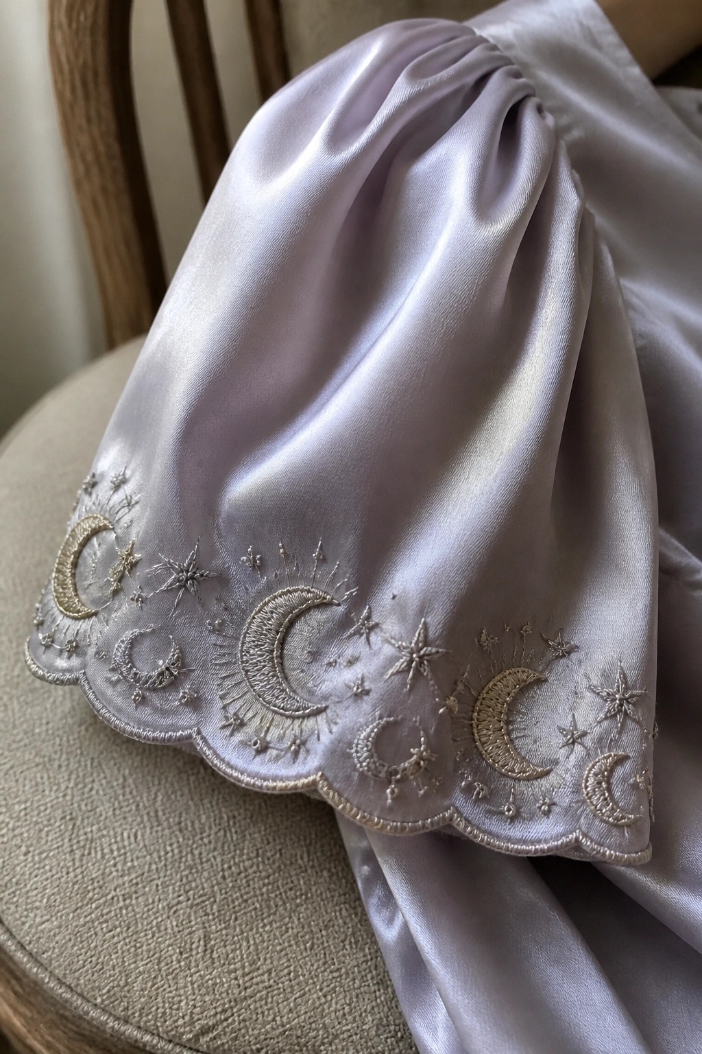 Lavender satin fabric embroidered with golden moons and stars on a chair