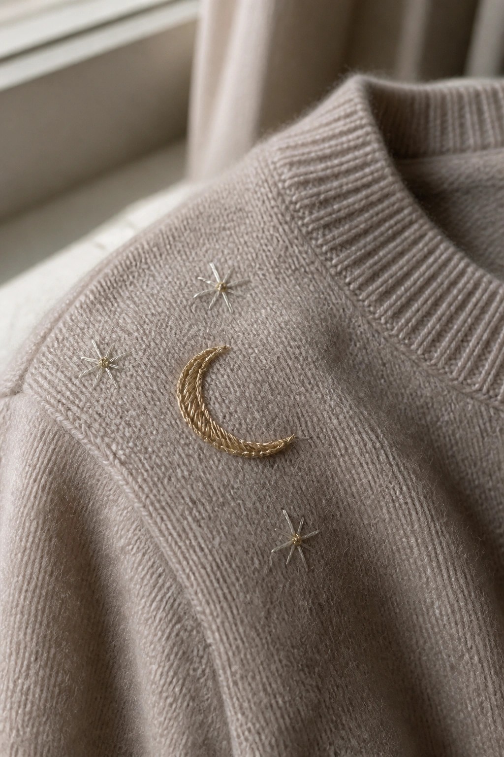 Beige knit sweater with gold crescent moon and silver star embroidery
