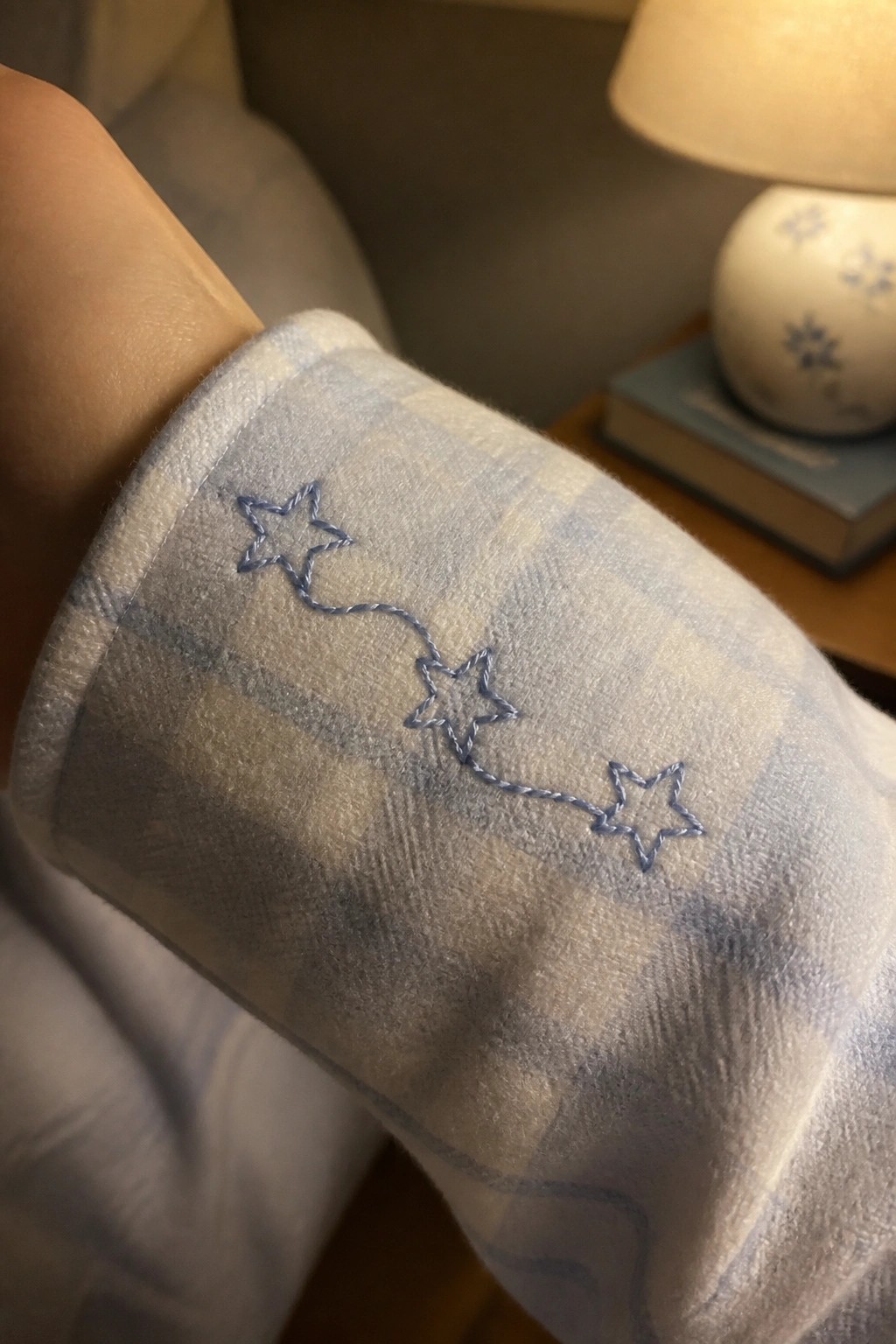 Light blue plaid pajama cuff with embroidered blue star constellation design