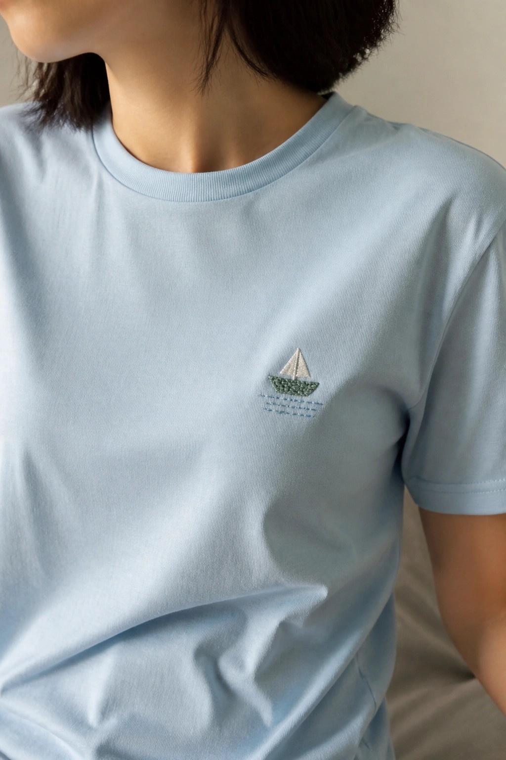 Light blue t-shirt with small embroidered sailboat on the chest